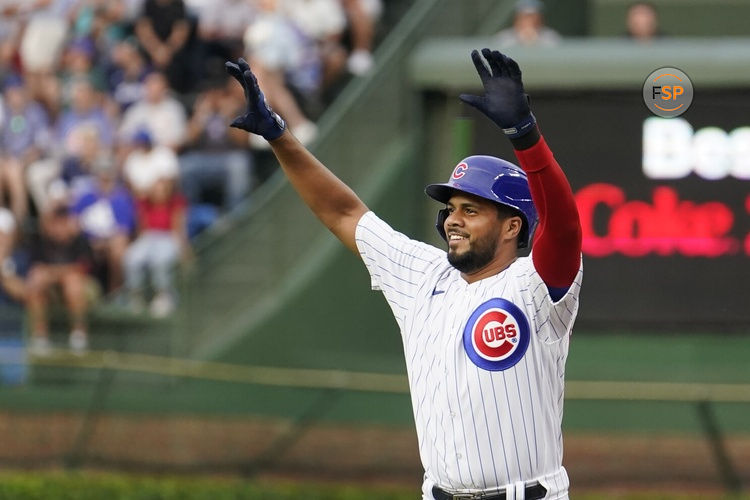 Chicago Cubs' Jeimer Candelario celebrates his single off Cincinnati Reds starting pitcher Ben Lively, after joining the Cubs in a trade with the Washington Nationals, during the first inning of a baseball game Tuesday, Aug. 1, 2023, in Chicago. (AP Photo/Charles Rex Arbogast)