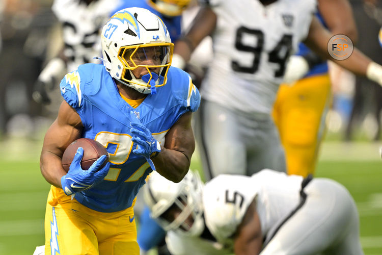 Sep 8, 2024; Inglewood, California, USA; Los Angeles Chargers running back J.K. Dobbins (27) breaks away from Las Vegas Raiders linebacker Divine Deablo (5) and runs for a touchdown in the second half at SoFi Stadium. Credit: Jayne Kamin-Oncea-Imagn Images