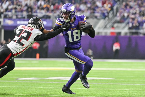 Dec 8, 2024; Minneapolis, Minnesota, USA; Minnesota Vikings wide receiver Justin Jefferson (18) gets yards after the catch as Atlanta Falcons cornerback Clark Phillips III (22) attempts to make the tackle during the fourth quarter at U.S. Bank Stadium. Mandatory Credit: Jeffrey Becker-Imagn Images