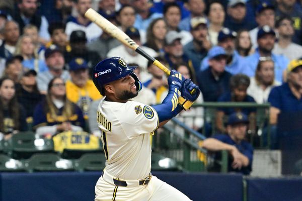 Oct 14, 2025; Milwaukee, Wisconsin, USA; Milwaukee Brewers right fielder Jackson Chourio (11) hits a solo home run against the Los Angeles Dodgers in the first inning during game two of the NLCS round for the 2025 MLB playoffs at American Family Field. Mandatory Credit: Benny Sieu-Imagn Images