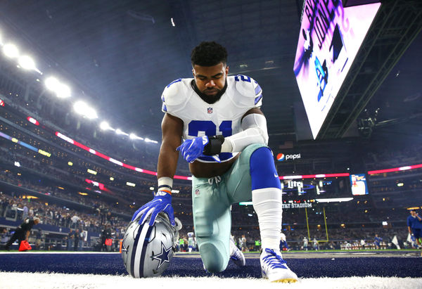 ARLINGTON, TX - DECEMBER 26: Ezekiel Elliott #21 of the Dallas Cowboys takes a knee in the end zone before the Cowboys played the Detroit Lions at AT&T Stadium on December 26, 2016 in Arlington, Texas. (Photo by Tom Pennington/Getty Images)