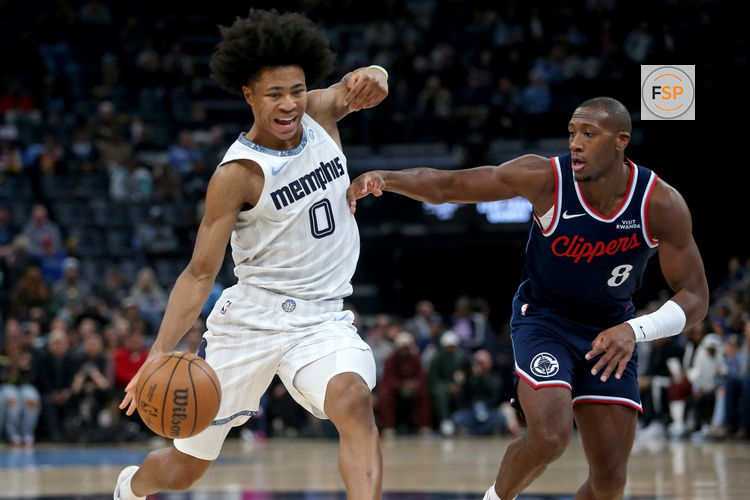 Dec 5, 2025; Memphis, Tennessee, USA; Memphis Grizzlies forward Jaylen Wells (0) drives to the basket as Los Angeles Clippers guard Kris Dunn (8) defends during the first quarter at FedExForum. Credit: Petre Thomas-Imagn Images