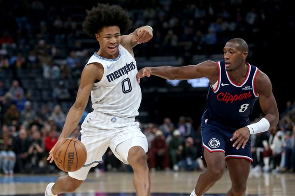 Dec 5, 2025; Memphis, Tennessee, USA; Memphis Grizzlies forward Jaylen Wells (0) drives to the basket as Los Angeles Clippers guard Kris Dunn (8) defends during the first quarter at FedExForum. Mandatory Credit: Petre Thomas-Imagn Images