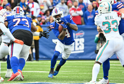 Nov 3, 2024; Orchard Park, New York, USA; Buffalo Bills running back James Cook (4) runs the ball against the Miami Dolphins in the third quarter at Highmark Stadium. Mandatory Credit: Mark Konezny-Imagn Images