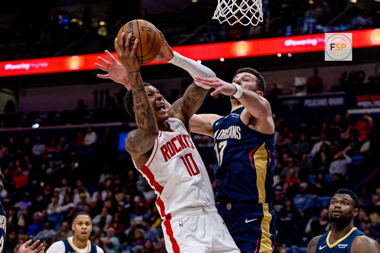 Mar 6, 2025; New Orleans, Louisiana, USA;  Houston Rockets forward Jabari Smith Jr. (10) dribbles against New Orleans Pelicans forward Zion Williamson (1) and center Karlo Matkovic (17) during the second half at Smoothie King Center. Credit: Stephen Lew-Imagn Images