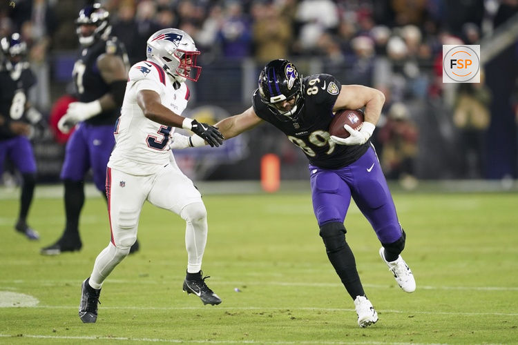 Dec 21, 2025; Baltimore, Maryland, USA;  Baltimore Ravens tight end Mark Andrews (89) runs against New England Patriots safety Craig Woodson (31) during the first half of the game at M&T Bank Stadium. Credit: Mitch Stringer-Imagn Images