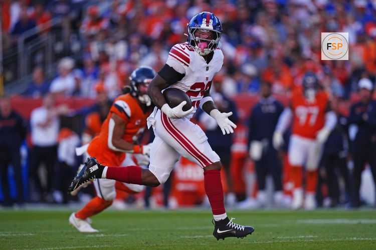 Oct 19, 2025; Denver, Colorado, USA; New York Giants running back Tyrone Tracy Jr. (29) runs the ball during the second half against the Denver Broncos at Empower Field at Mile High. Credit: Ron Chenoy-Imagn Images