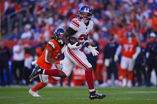 Oct 19, 2025; Denver, Colorado, USA; New York Giants running back Tyrone Tracy Jr. (29) runs the ball during the second half against the Denver Broncos at Empower Field at Mile High. Mandatory Credit: Ron Chenoy-Imagn Images
