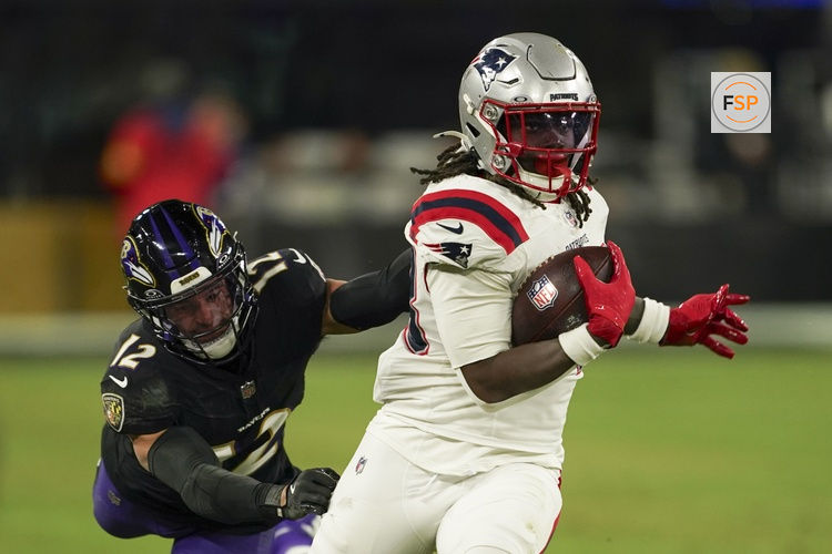 Dec 21, 2025; Baltimore, Maryland, USA;  New England Patriots running back Rhamondre Stevenson (38) runs the ball against Baltimore Ravens safety Alohi Gilman (12) during the second half of the game at M&T Bank Stadium. Credit: Mitch Stringer-Imagn Images