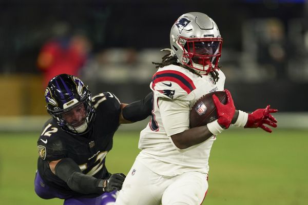 Dec 21, 2025; Baltimore, Maryland, USA;  New England Patriots running back Rhamondre Stevenson (38) runs the ball against Baltimore Ravens safety Alohi Gilman (12) during the second half of the game at M&T Bank Stadium. Mandatory Credit: Mitch Stringer-Imagn Images