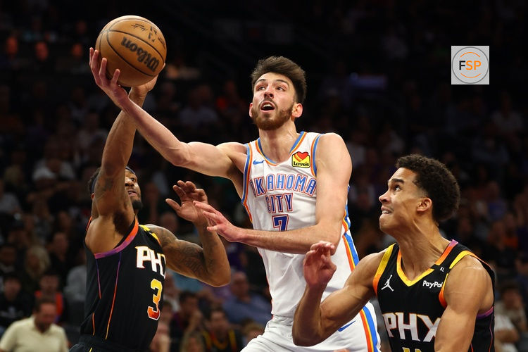 Apr 9, 2025; Phoenix, Arizona, USA; Oklahoma City Thunder forward Chet Holmgren (7) shoots the ball over Phoenix Suns guard Bradley Beal (3) and center Bol Bol (11) during the second half at Footprint Center. Credit: Mark J. Rebilas-Imagn Images