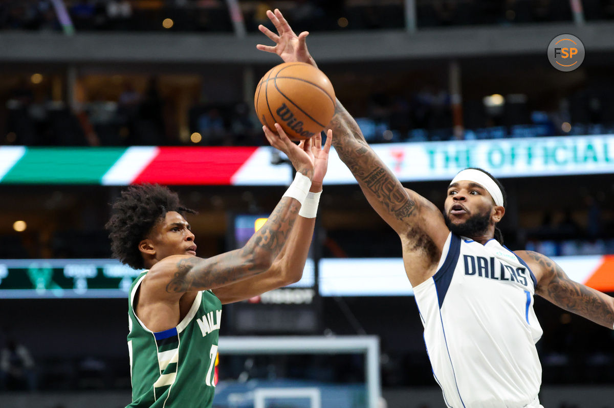 Oct 17, 2024; Dallas, Texas, USA;  Milwaukee Bucks guard AJ Johnson (77) shoots as Dallas Mavericks guard Jaden Hardy (1) defends during the second half at American Airlines Center. Credit: Kevin Jairaj-Imagn Images