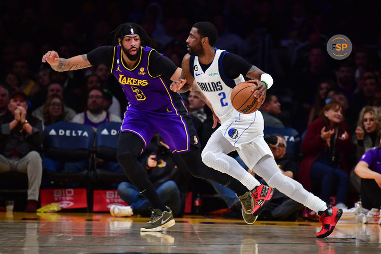 Mar 17, 2023; Los Angeles, California, USA; Dallas Mavericks guard Kyrie Irving (2) moves the ball against Los Angeles Lakers forward Anthony Davis (3) during the second half at Crypto.com Arena. Credit: Gary A. Vasquez-USA TODAY Sports