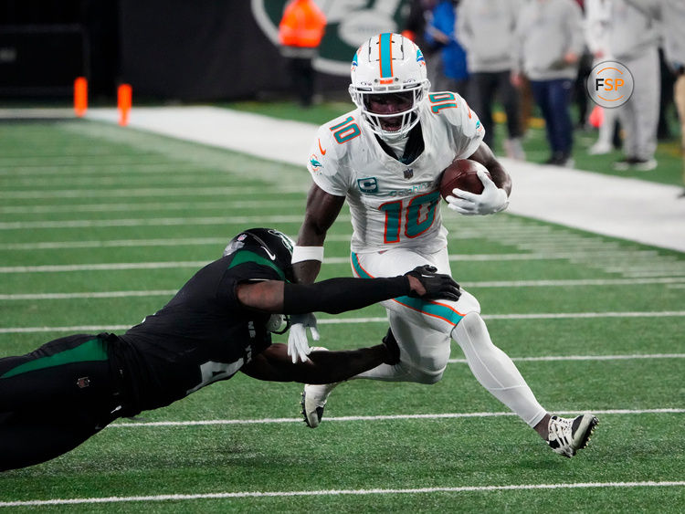 Nov 24, 2023; East Rutherford, New Jersey, USA; Miami Dolphins wide receiver Tyreek Hill (10) is tackled by New York Jets cornerback D.J. Reed (4) in the second half at MetLife Stadium. Credit: Robert Deutsch-USA TODAY Sports