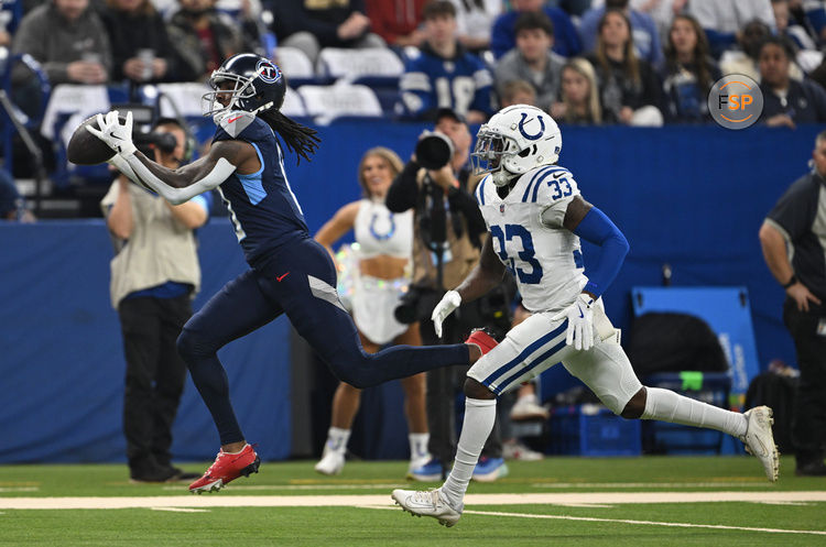 Dec 22, 2024; Indianapolis, Indiana, USA; Tennessee Titans wide receiver Calvin Ridley (0) catches a long pass in front of Indianapolis Colts cornerback Samuel Womack III (33) for a touchdown during the first quarter at Lucas Oil Stadium. Credit: Marc Lebryk-Imagn Images