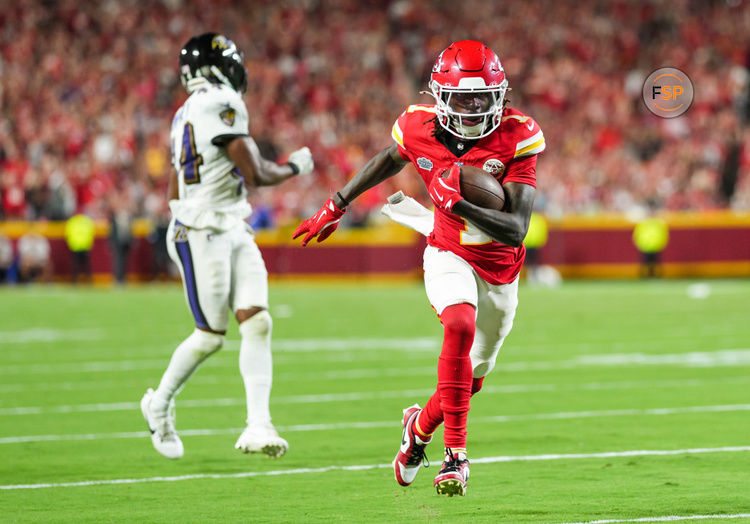 Sep 5, 2024; Kansas City, Missouri, USA; Kansas City Chiefs wide receiver Xavier Worthy (1) scores a touchdown against Baltimore Ravens cornerback Marlon Humphrey (44) during the second half at GEHA Field at Arrowhead Stadium. Credit: Jay Biggerstaff-Imagn Images