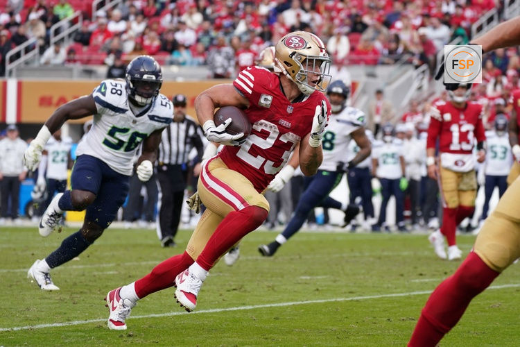 Nov 17, 2024; Santa Clara, California, USA; San Francisco 49ers running back Christian McCaffrey (23) rushes the ball while be pursued by Seattle Seahawks linebacker Derick Hall (58) in the fourth quarter at Levi's Stadium. Credit: David Gonzales-Imagn Images