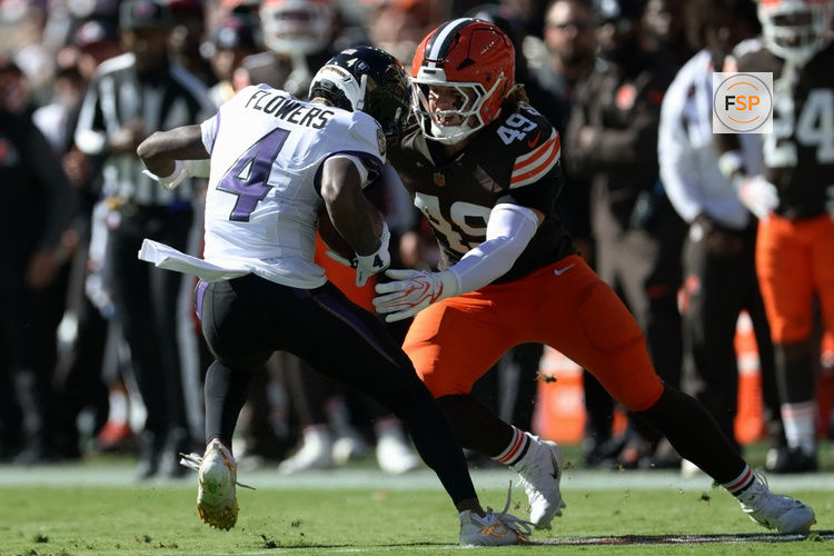 Oct 18, 2026; Cleveland, Ohio, USA;  Baltimore Ravens wide receiver Zay Flowers (4) runs through the tackle of Cleveland Browns linebacker Carson Schwesinger (49) in the second quarter at Huntington Bank Field.  Credit: Scott Galvin-Imagn Images