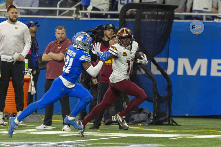 Jan 18, 2025; Detroit, Michigan, USA; Washington Commanders wide receiver Terry McLaurin (17) runs the ball against Detroit Lions safety Kerby Joseph (31)  during the second quarter at Ford Field. Credit: David Reginek-Imagn Images