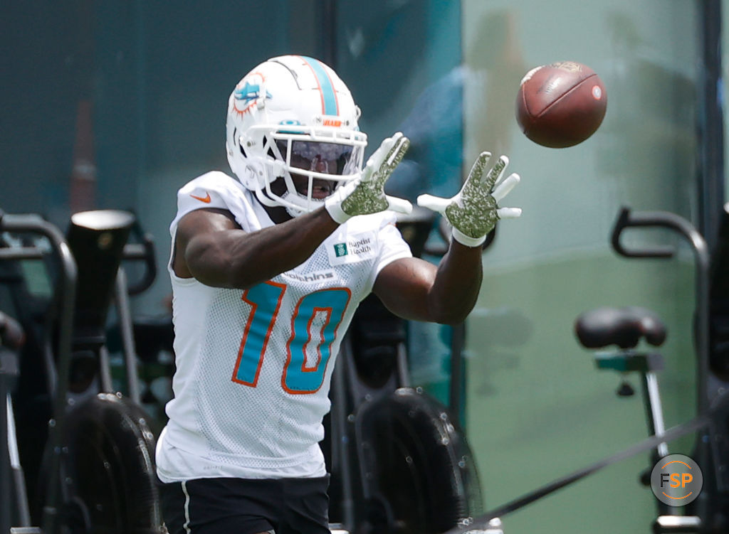 MIAMI GARDENS, FL - MAY 24: Tyreek Hill #10 of the Miami Dolphins catches the ball during the Miami Dolphins OTAs at the Baptist Health Training Complex on May 24, 2022 in Miami Gardens, Florida. (Photo by Joel Auerbach/Getty Images) *** Local Caption *** Tyreek Hill