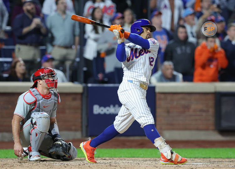 Oct 9, 2024; New York, New York, USA; New York Mets shortstop Francisco Lindor (12) hits a grand slam against the Philadelphia Phillies in the sixth inning in game four of the NLDS for the 2024 MLB Playoffs at Citi Field. Credit: Brad Penner-Imagn Images