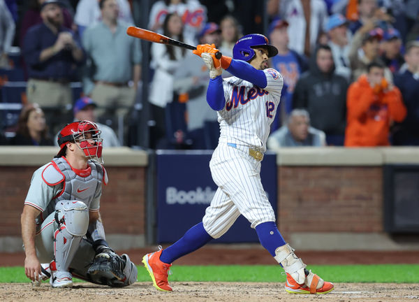 Oct 9, 2024; New York, New York, USA; New York Mets shortstop Francisco Lindor (12) hits a grand slam against the Philadelphia Phillies in the sixth inning in game four of the NLDS for the 2024 MLB Playoffs at Citi Field. Mandatory Credit: Brad Penner-Imagn Images