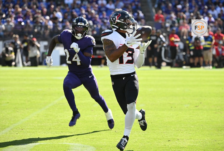 Oct 5, 2025; Baltimore, Maryland, USA; Houston Texans wide receiver Christian Kirk (13) catches a pass past Baltimore Ravens safety Malaki Starks (24) during the fourth quarter at M&T Bank Stadium. Credit: Rafael Suanes-Imagn Images