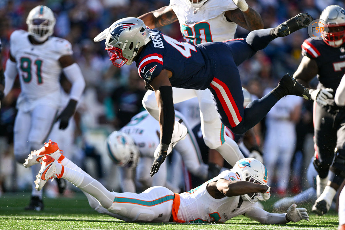 Oct 6, 2024; Foxborough, Massachusetts, USA; New England Patriots running back Antonio Gibson (4) runs against the Miami Dolphins during the second half at Gillette Stadium. Credit: Brian Fluharty-Imagn Images