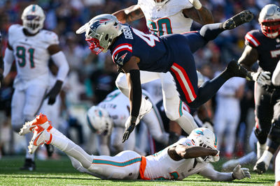 Oct 6, 2024; Foxborough, Massachusetts, USA; New England Patriots running back Antonio Gibson (4) runs against the Miami Dolphins during the second half at Gillette Stadium. Mandatory Credit: Brian Fluharty-Imagn Images