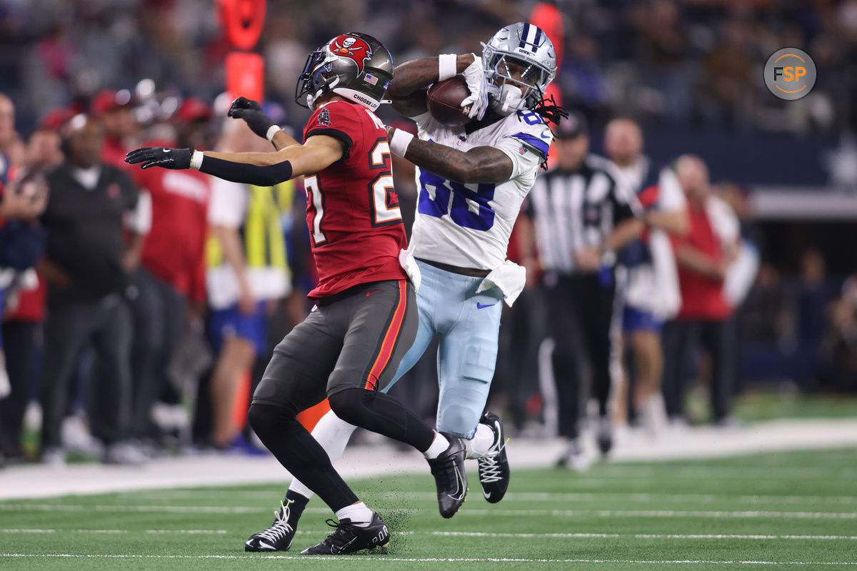 Dec 22, 2024; Arlington, Texas, USA; Dallas Cowboys wide receiver CeeDee Lamb (88) catches a pass against Tampa Bay Buccaneers cornerback Zyon McCollum (27) in the second quarter at AT&T Stadium. Credit: Tim Heitman-Imagn Images