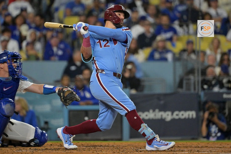 Oct 8, 2025; Los Angeles, California, USA; Philadelphia Phillies designated hitter Kyle Schwarber (12) hits a solo home run during the fourth inning against the Los Angeles Dodgers in game three of the NLDS during the 2025 MLB playoffs at Dodger Stadium. Credit: Jayne Kamin-Oncea-Imagn Images