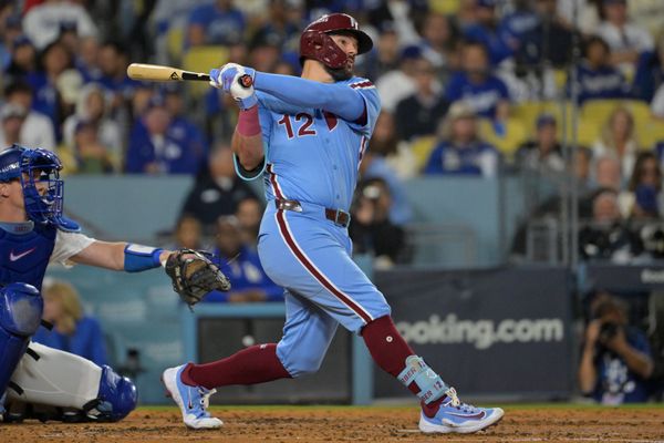Oct 8, 2025; Los Angeles, California, USA; Philadelphia Phillies designated hitter Kyle Schwarber (12) hits a solo home run during the fourth inning against the Los Angeles Dodgers in game three of the NLDS during the 2025 MLB playoffs at Dodger Stadium. Mandatory Credit: Jayne Kamin-Oncea-Imagn Images