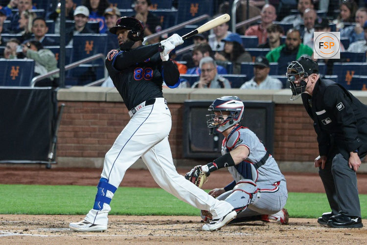 Apr 23, 2026; New York City, New York, USA;  New York Mets center fielder Luis Robert Jr. (88) hits an RBI double during the second inning against the Minnesota Twins at Citi Field. Credit: Vincent Carchietta-Imagn Images