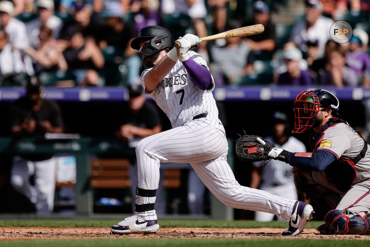 Aug 11, 2024; Denver, Colorado, USA; Colorado Rockies second baseman Brendan Rodgers (7) hits a two RBI double in the eighth inning against the Atlanta Braves at Coors Field. Credit: Isaiah J. Downing-USA TODAY Sports