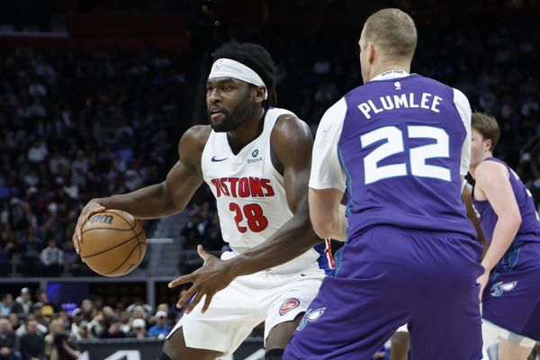 Dec 20, 2025; Detroit, Michigan, USA;  Detroit Pistons forward Isaiah Stewart (28) dribbles defended by Charlotte Hornets center Mason Plumlee (22) in the first half at Little Caesars Arena. Mandatory Credit: Rick Osentoski-Imagn Images