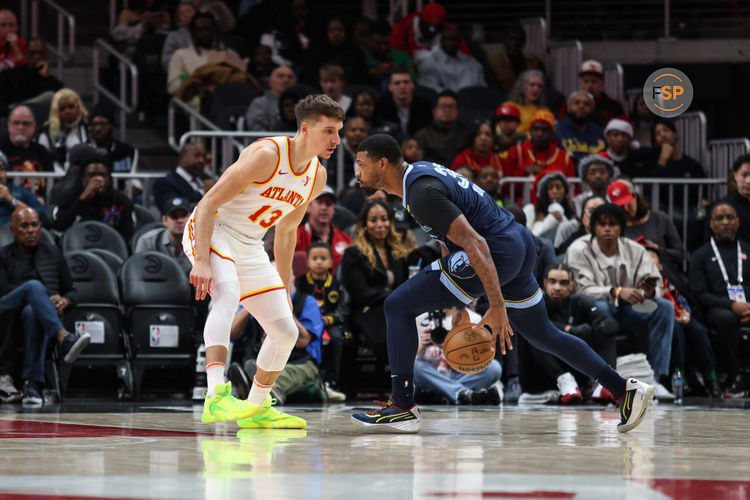 Dec 21, 2024; Atlanta, Georgia, USA; Atlanta Hawks guard Bogdan Bogdanovic (13) plays defense against Memphis Grizzlies guard Marcus Smart (36) during the first half at State Farm Arena. Credit: Jordan Godfree-Imagn Images