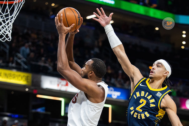 Jan 14, 2025; Indianapolis, Indiana, USA; Cleveland Cavaliers forward Evan Mobley (4) shoots the ball while Indiana Pacers guard Andrew Nembhard (2) defends in the first half at Gainbridge Fieldhouse. Credit: Trevor Ruszkowski-Imagn Images