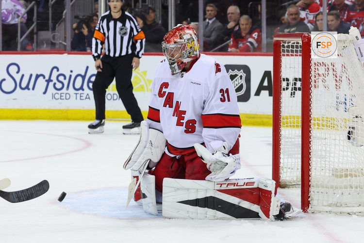 Apr 25, 2025; Newark, New Jersey, USA; Carolina Hurricanes goaltender Frederik Andersen (31) makes a save against the New Jersey Devils during the first overtime in game three of the first round of the 2025 Stanley Cup Playoffs at Prudential Center. Credit: Ed Mulholland-Imagn Images