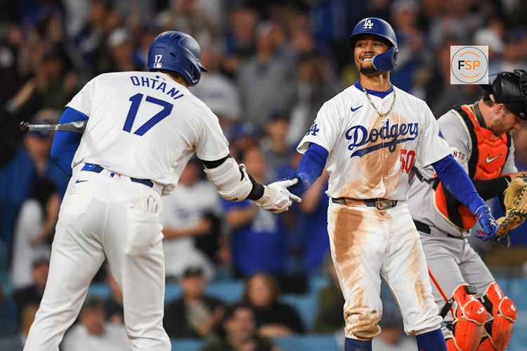 LOS ANGELES, CA - APRIL 02: Los Angeles Dodgers shortstop Mookie Betts (50) celebrates with Los Angeles Dodgers designated hitter Shohei Ohtani (17) after hitting a home run during the MLB game between the San Francisco Giants and the Los Angeles Dodgers on April 2, 2024 at Dodger Stadium in Los Angeles, CA. (Photo by Brian Rothmuller/Icon Sportswire)

