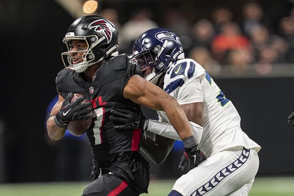 Dec 7, 2025; Atlanta, Georgia, USA; Atlanta Falcons running back Bijan Robinson (7) is tackled by Seattle Seahawks cornerback Riq Woolen (27) at Mercedes-Benz Stadium. Mandatory Credit: Dale Zanine-Imagn Images