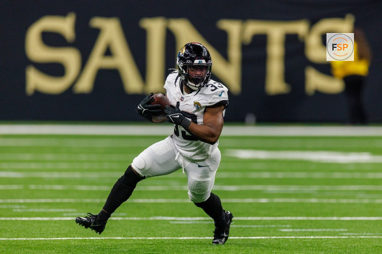 Aug 17, 2025; New Orleans, Louisiana, USA;  Jacksonville Jaguars running back Bhayshul Tuten (33) runs against the New Orleans Saints during the first half at Caesars Superdome. Credit: Stephen Lew-Imagn Images