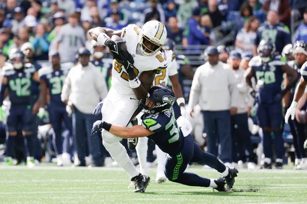Sep 21, 2025; Seattle, Washington, USA; Seattle Seahawks safety Ty Okada (39) tackles New Orleans Saints tight end Juwan Johnson (83) following the catch during the first quarter at Lumen Field. Mandatory Credit: Joe Nicholson-Imagn Images