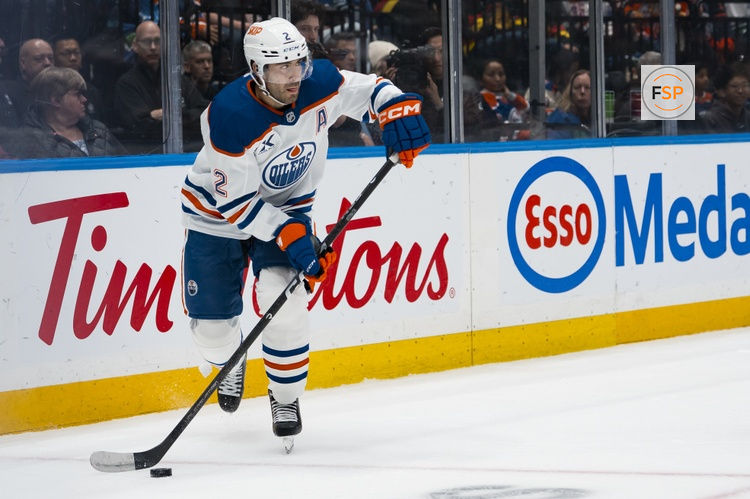 Oct 1, 2026; Vancouver, British Columbia, CAN; Edmonton Oilers defenseman Evan Bouchard (2) handles the puck against the Vancouver Canucks in the third period at Rogers Arena. Credit: Bob Frid-Imagn Images