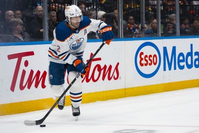 Oct 1, 2026; Vancouver, British Columbia, CAN; Edmonton Oilers defenseman Evan Bouchard (2) handles the puck against the Vancouver Canucks in the third period at Rogers Arena. Mandatory Credit: Bob Frid-Imagn Images