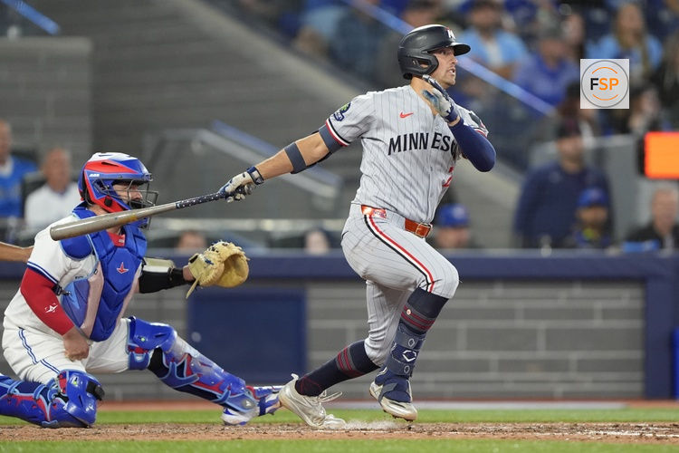 Aug 25, 2025; Toronto, Ontario, CAN; Minnesota Twins shortstop Brooks Lee (2) gets an RBI in a ground out to the Toronto Blue Jays during the seventh inning at Rogers Centre. Credit: John E. Sokolowski-Imagn Images