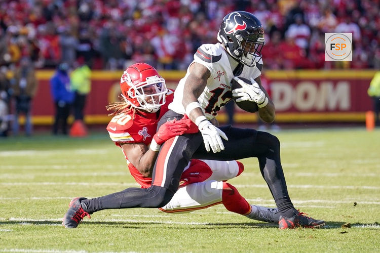 Dec 21, 2024; Kansas City, Missouri, USA; Houston Texans wide receiver Nico Collins (12) runs the ball as Kansas City Chiefs safety Justin Reid (20) makes the tackle during the first half at GEHA Field at Arrowhead Stadium. Credit: Denny Medley-Imagn Images