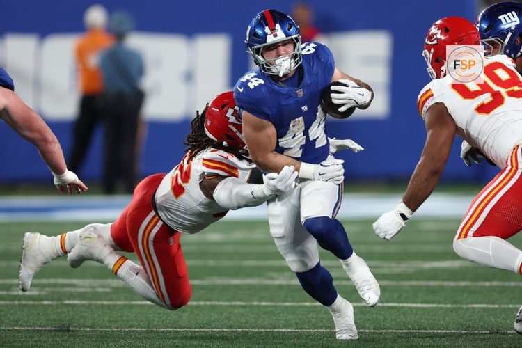 Sep 21, 2025; East Rutherford, New Jersey, USA; New York Giants running back Cam Skattebo (44) runs against Kansas City Chiefs linebacker Nick Bolton (32) in the second quarter at MetLife Stadium. Credit: Vincent Carchietta-Imagn Images
