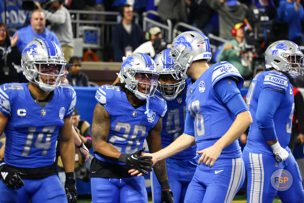 DETROIT, MI - JANUARY 21:  Detroit Lions running back Jahmyr Gibbs (26) is congratulated by Detroit Lions quarterback Jared Goff (16) after scoring a touchdown on a running play during an NFL NFC Divisional playoff football game between the Tampa Bay Buccaneers and the Detroit Lions on January 21, 2024 at Ford Field in Detroit, Michigan. (Photo by Scott W. Grau/Icon Sportswire)