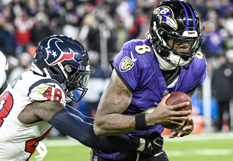 BALTIMORE, MD - JANUARY 20:  Baltimore Ravens quarterback Lamar Jackson (8) is sacked by Houston Texans linebacker Christian Harris (48) during the Houston Texans game versus the Baltimore Ravens in the AFC Divisional Playoffs on January 20, 2024 at M&T Bank Stadium in Baltimore, MD.  (Photo by Mark Goldman/Icon Sportswire)