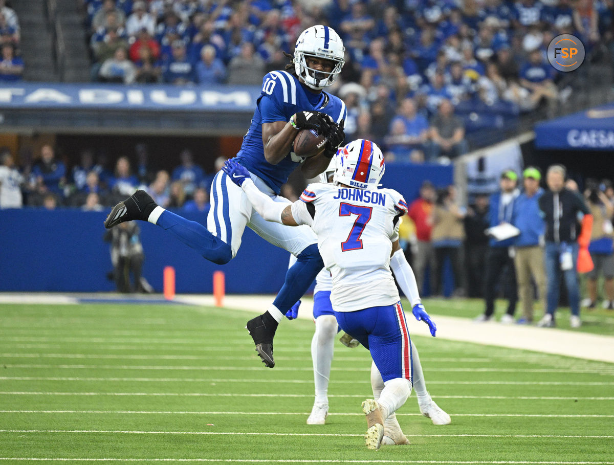 Nov 10, 2024; Indianapolis, Indiana, USA; Indianapolis Colts wide receiver Adonai Mitchell (10) catches the ball in front of Buffalo Bills cornerback Taron Johnson (7) during the second half at Lucas Oil Stadium. Credit: Marc Lebryk-Imagn Images